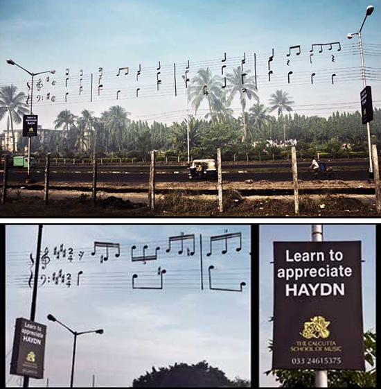 音楽教室(calcutta school of music)の屋外広告。譜面に見立てたのは送電線、危険過ぎて日本ではまずありえませんよね。<インド>
